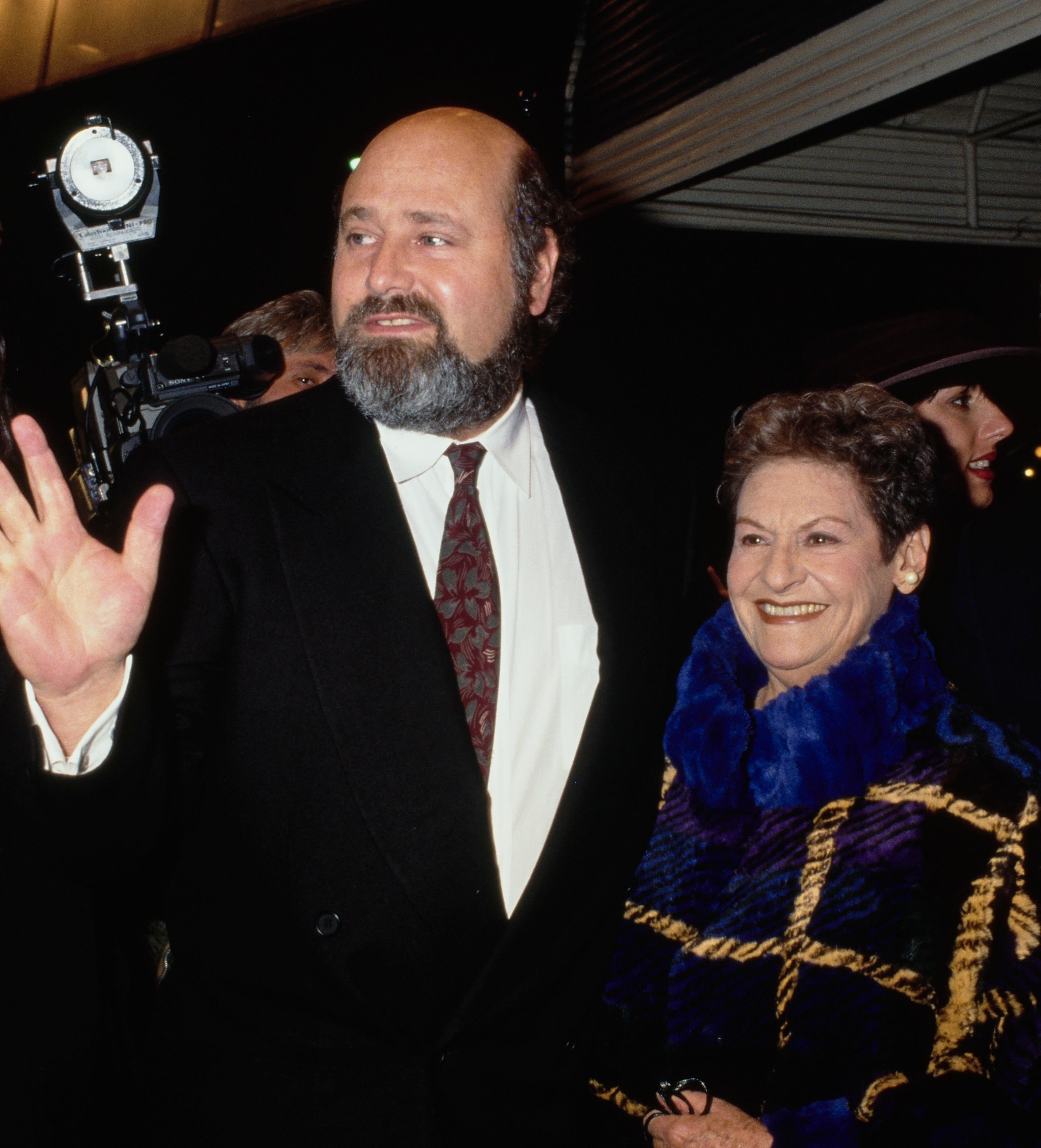 Four radical   airs  connected  a reddish  carpet; 1  waves. They deterioration  ceremonial  attire, including suits and a patterned coat. They look  pleased