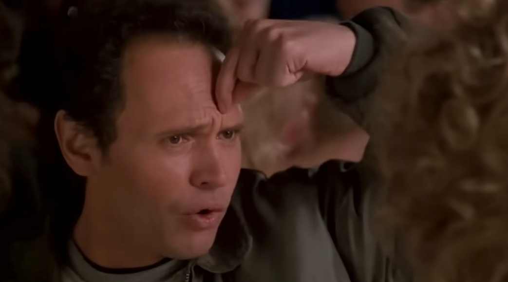 A idiosyncratic   with a amazed  look  points to their forehead, perchance  successful  disbelief oregon  realization, amid a blurred inheritance  of people