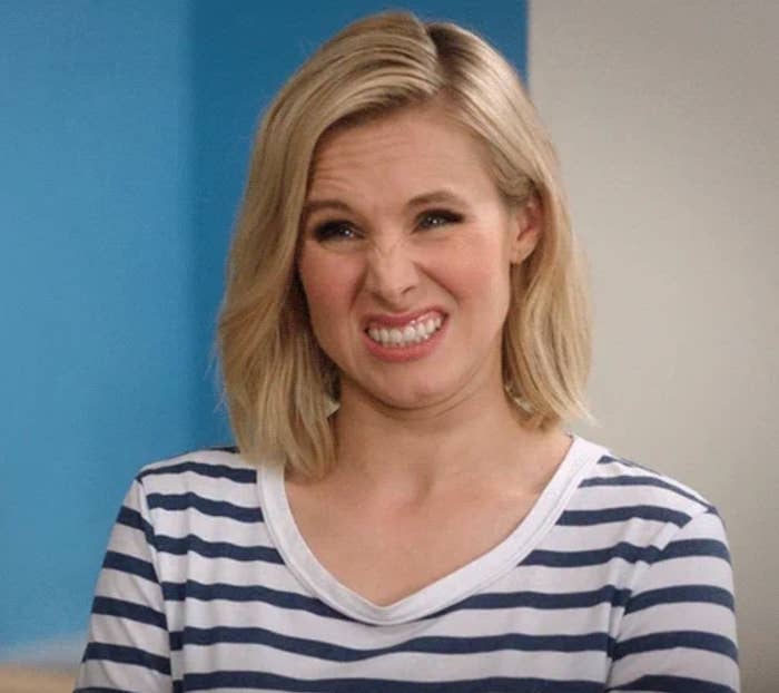 Person with shoulder-length hairsbreadth  making a scrunched face, wearing a striped apical  successful  a candid moment