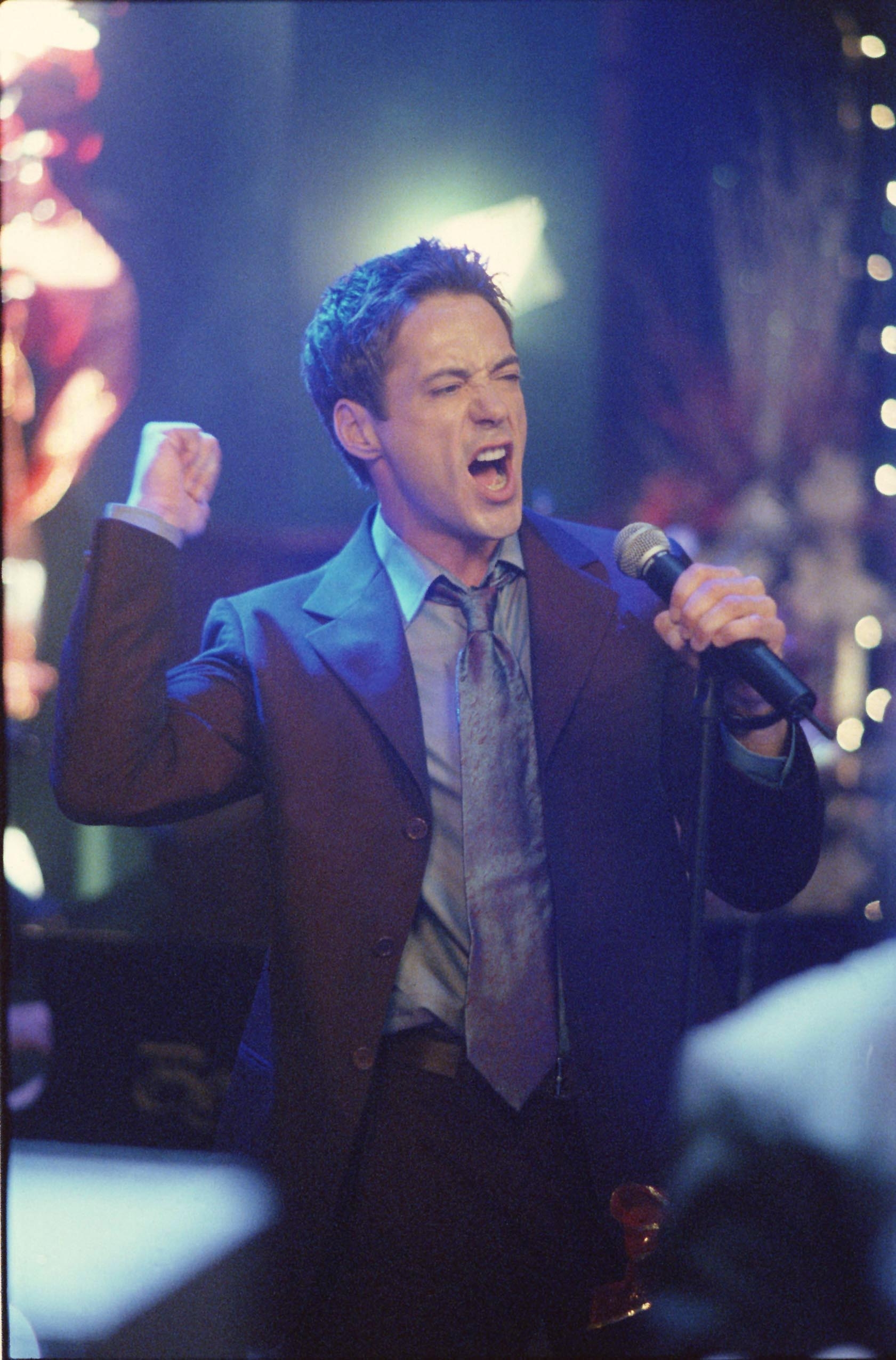 downey jr. sings into a microphone on the show