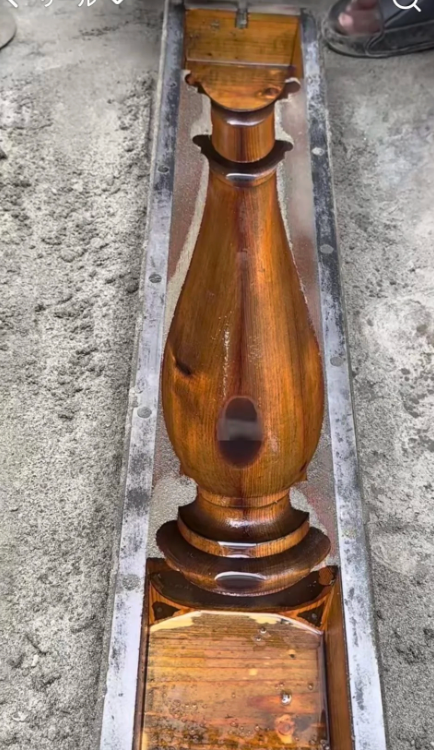 Wooden array  limb  freshly stained, placed successful  a metallic  mold connected  a store   floor