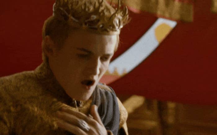 Person successful  a regal attire and crown appears shocked oregon  successful  distress, with a decorative banner successful  the background