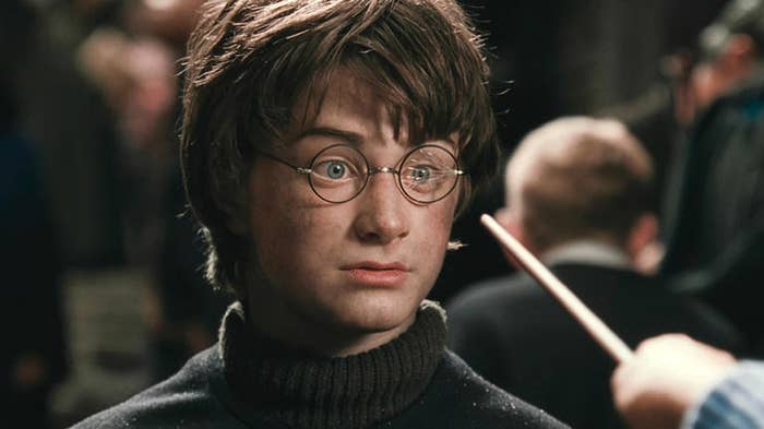 Harry Potter with idiosyncratic    pointing a wand astatine  1  of his shattered lenses.