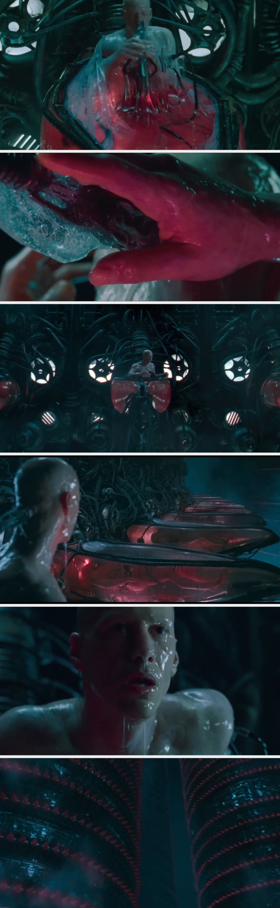 A person emerges from a cocoon-like pod filled with fluid, surrounded by futuristic, mechanical structures