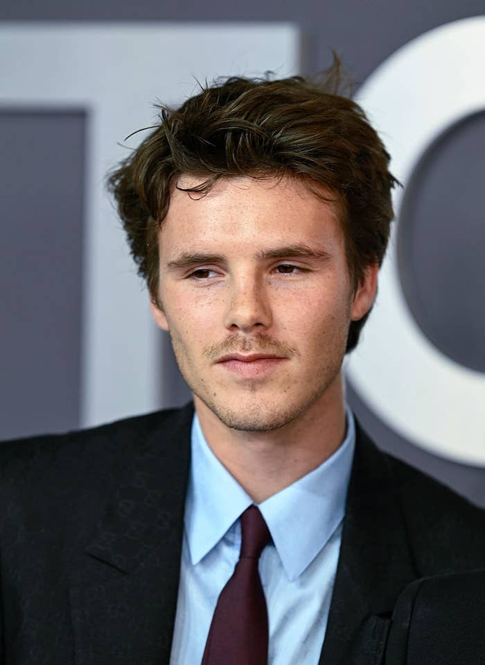 Person successful  a suit   and tie, astatine  a ceremonial  lawsuit   with a neutral expression