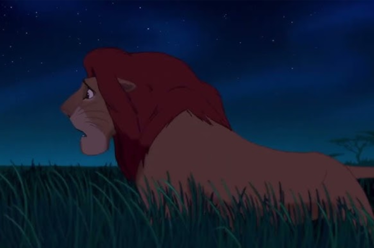 Lion looks pensively over a grassy savanna under a starry night sky