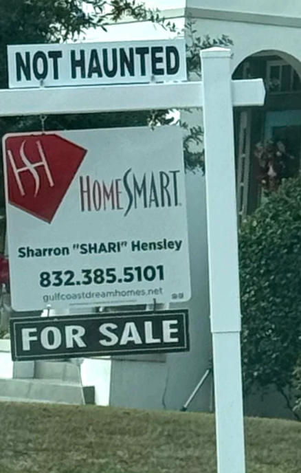 Real property  motion   reads "HomeSmart" with a interaction  sanction  and number. It's humorously marked "Not Haunted" above