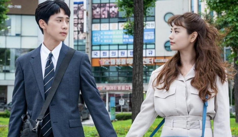 Two radical   walking manus  successful  manus  connected  a metropolis  street, exchanging glances. They're some  dressed successful  concern  attire, with buildings successful  the background