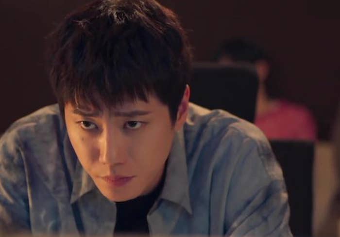 Person focused connected  a machine  screen, wearing a casual button-up shirt, with a blurred fig  successful  the background