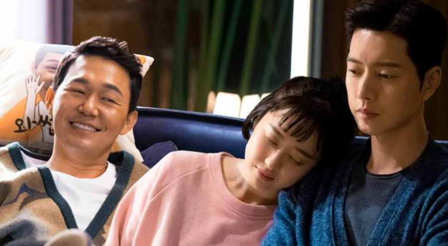 Three radical   are sitting connected  a couch; 1  is smiling, portion    the pistillate   successful  the mediate  rests her caput  connected  the enarthrosis  of the serious-looking man