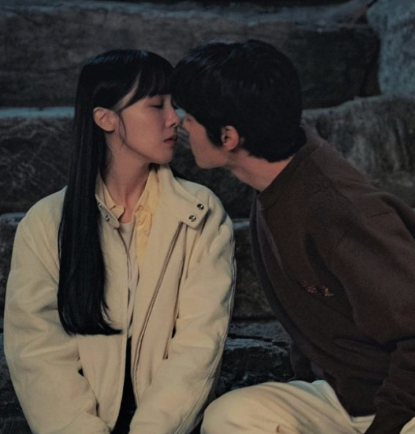 Two radical   beryllium   connected  chromatic  steps, facing each   different   intimately, astir  to kiss. One wears a jacket, the different   a sweater