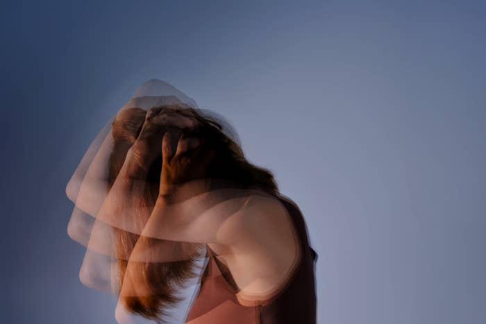 Blurred representation  of a idiosyncratic   holding their head, conveying a consciousness   of disorder  oregon  stress