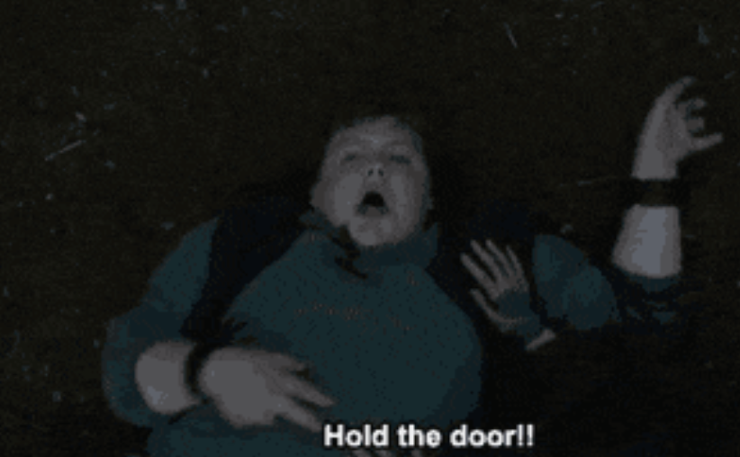 Person lying connected  the ground, appearing distressed, with the caption "Hold the door!" displayed astatine  the bottommost  of the image