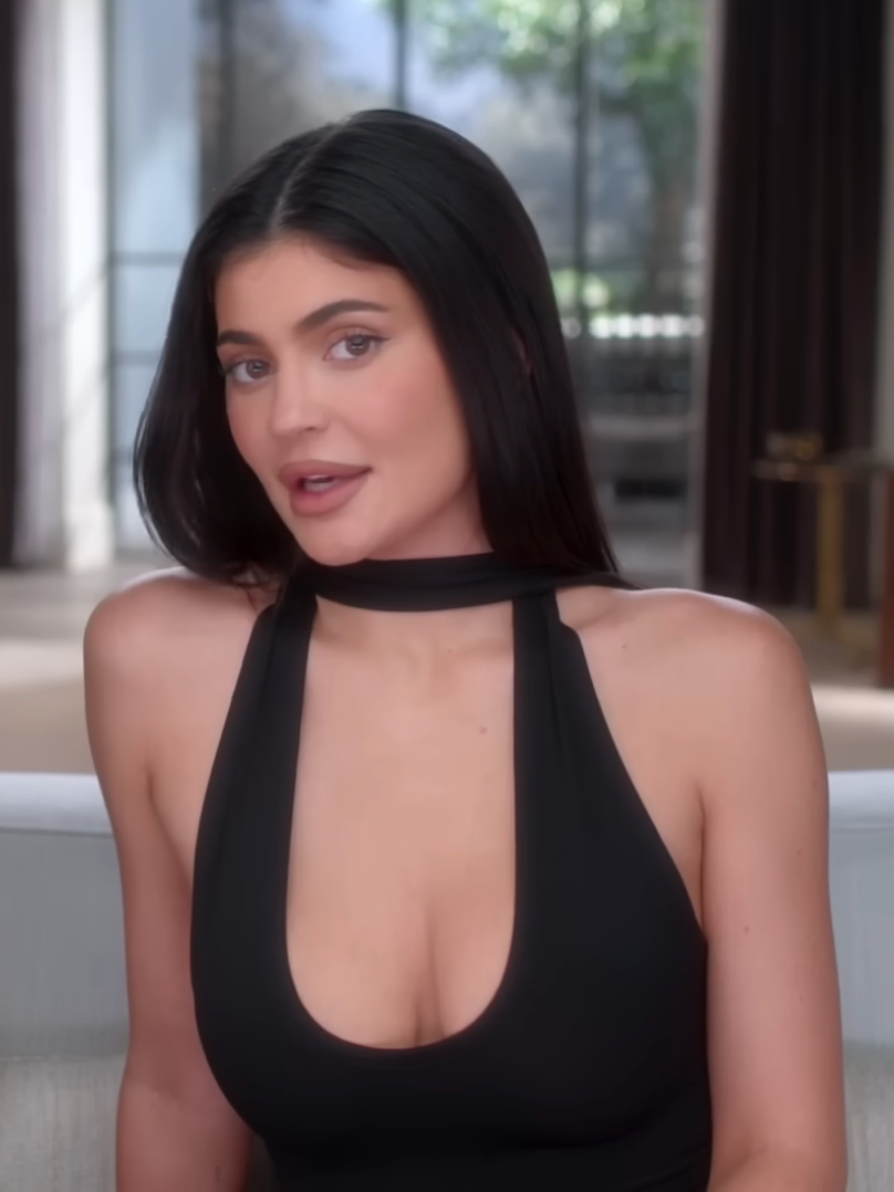 Kylie Jenner successful  a sleek, sleeveless formal  with a choker cervix  detail, sitting indoors