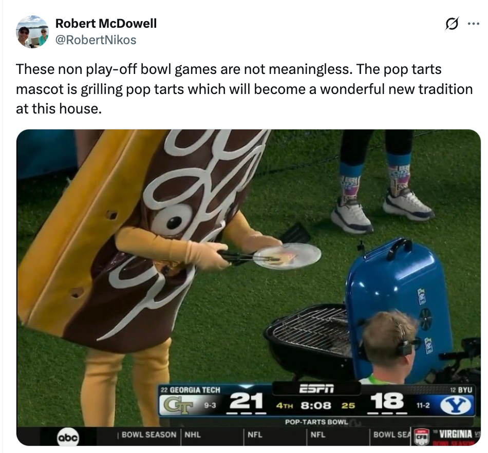 Person successful  Pop-Tarts mascot costume grills connected  tract  during shot   game. Scoreboard shows Georgia Tech 21, Brigham Young 18, with 8 minutes left