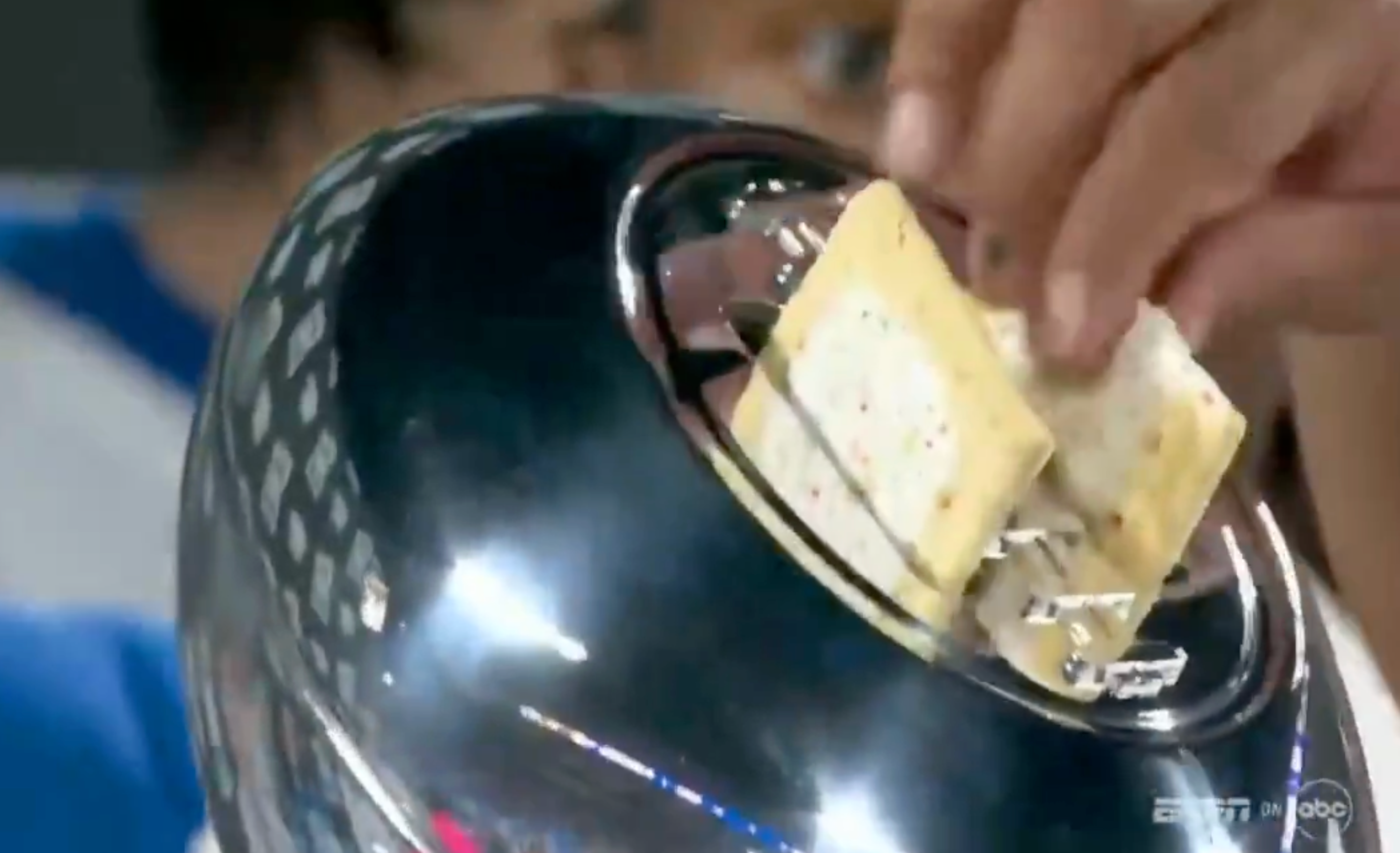 A manus  places crackers connected  a shiny surface; apt  portion  of a nutrient  contention   oregon  humorous display