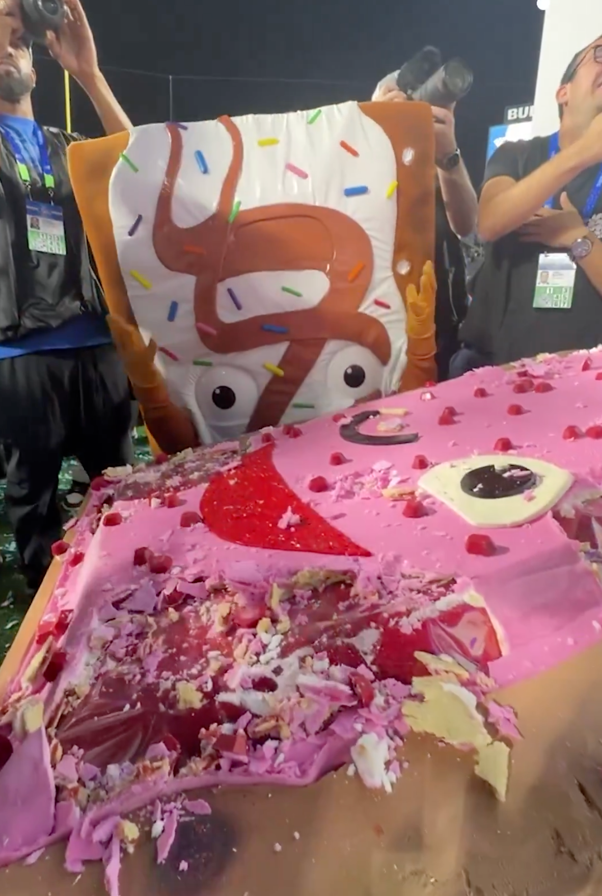 People successful  costume cutting a ample  barroom   with a cartoon-like, sprinkled plan  astatine  an event