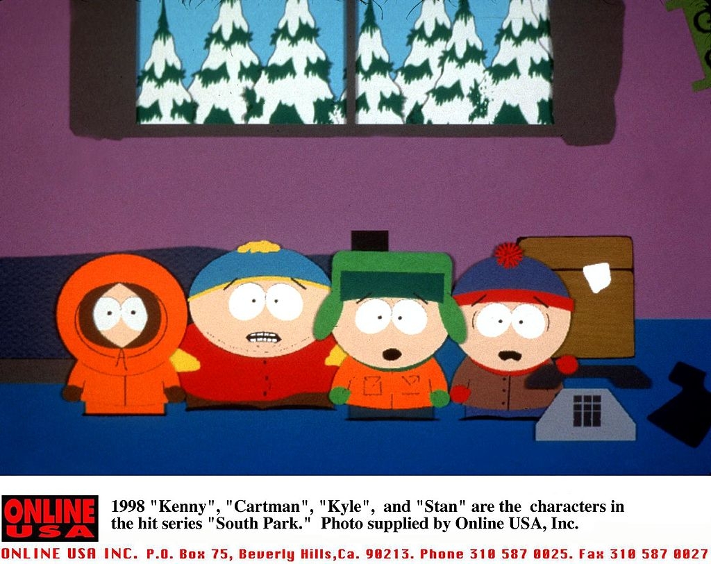 Animated characters Kenny, Cartman, Kyle, and Stan from "South Park" stand together indoors