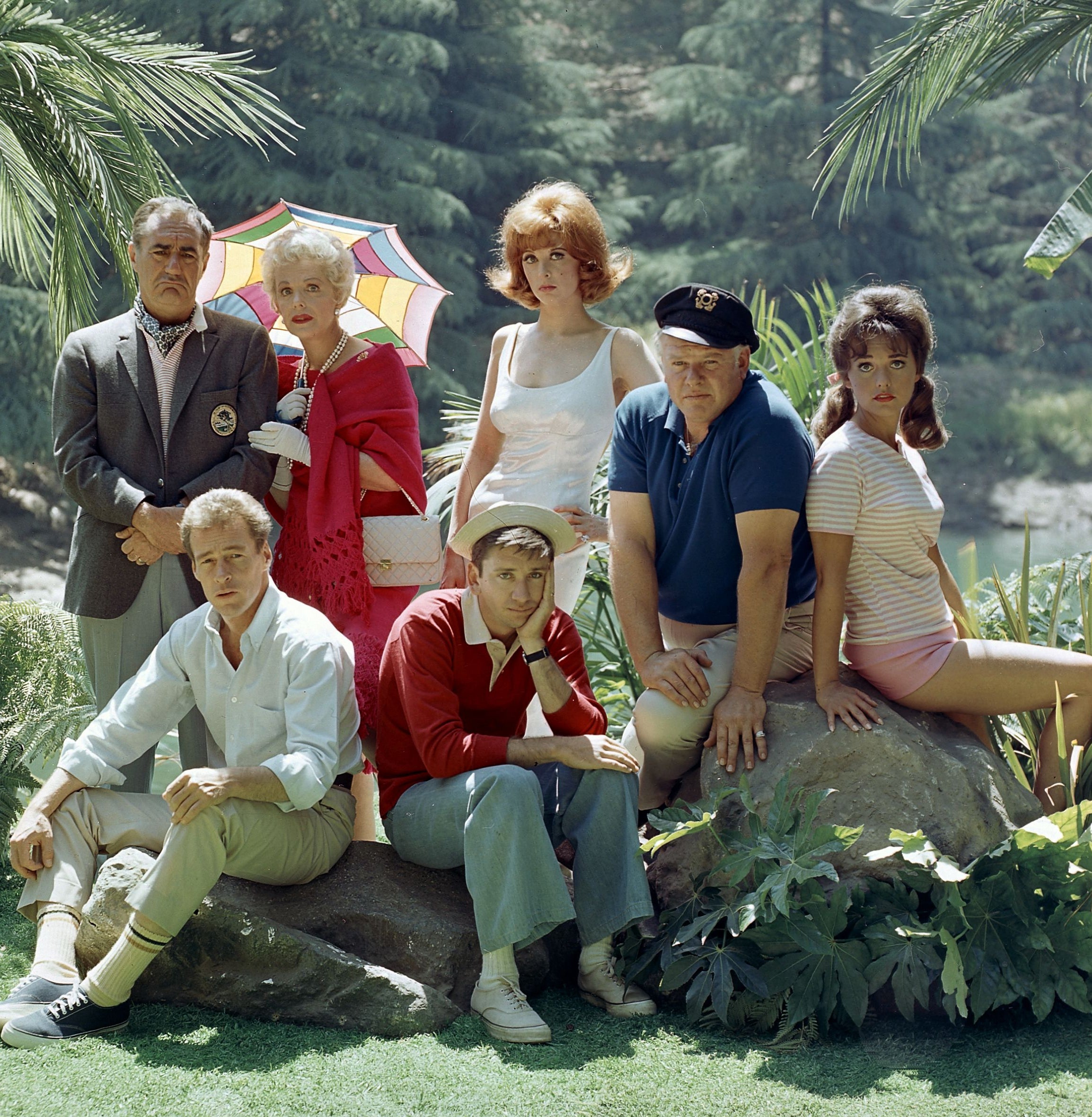 Cast of a classic TV show posing outdoors, with characters in varied, casual 1960s attire