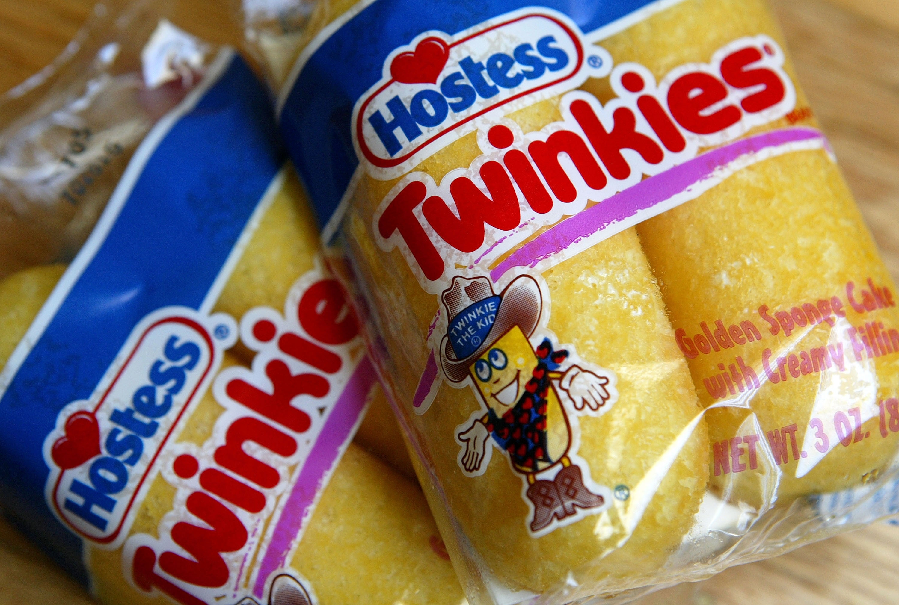 Two packages of Hostess Twinkies, featuring a cartoon character on the packaging