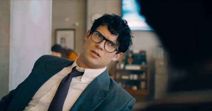 Clark Kent with glasses looks astatine  idiosyncratic    disconnected  camera.