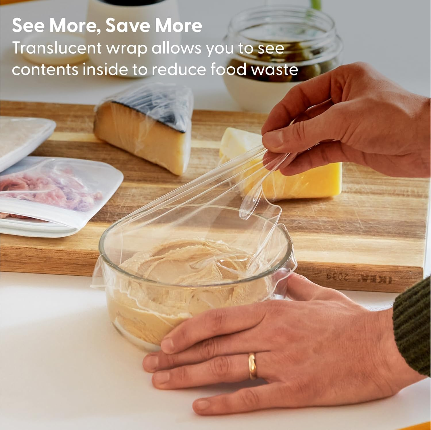 thick clear wrap being pulled over a bowl 