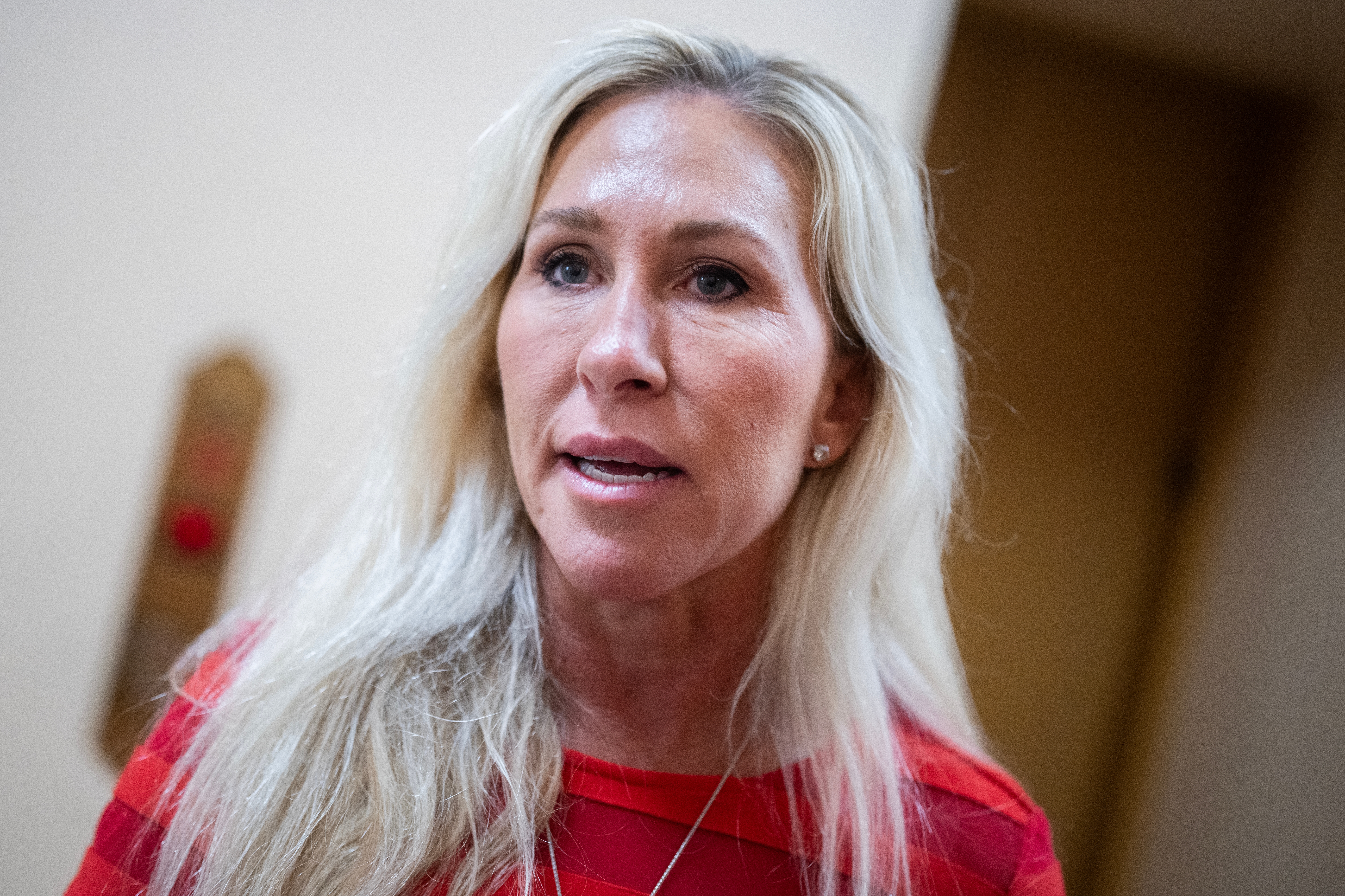 marjorie taylor greene with agelong  hairsbreadth  and a reddish  apical  speaking, indoors