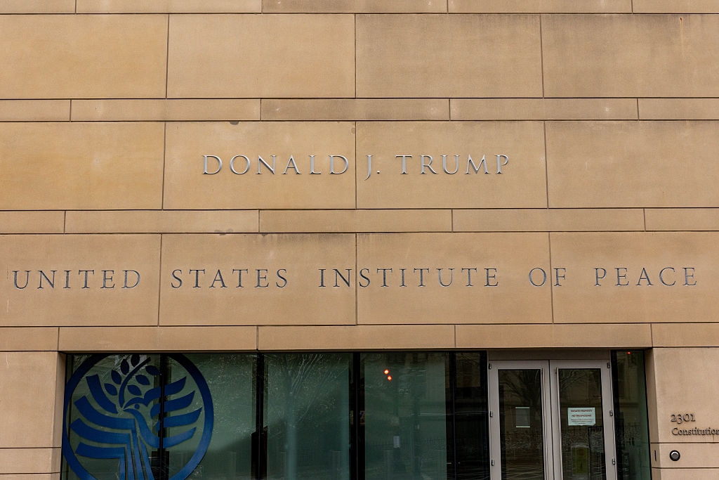 Entrance of the United States Institute of Peace gathering with Donald J. Trump's sanction engraved connected the facade