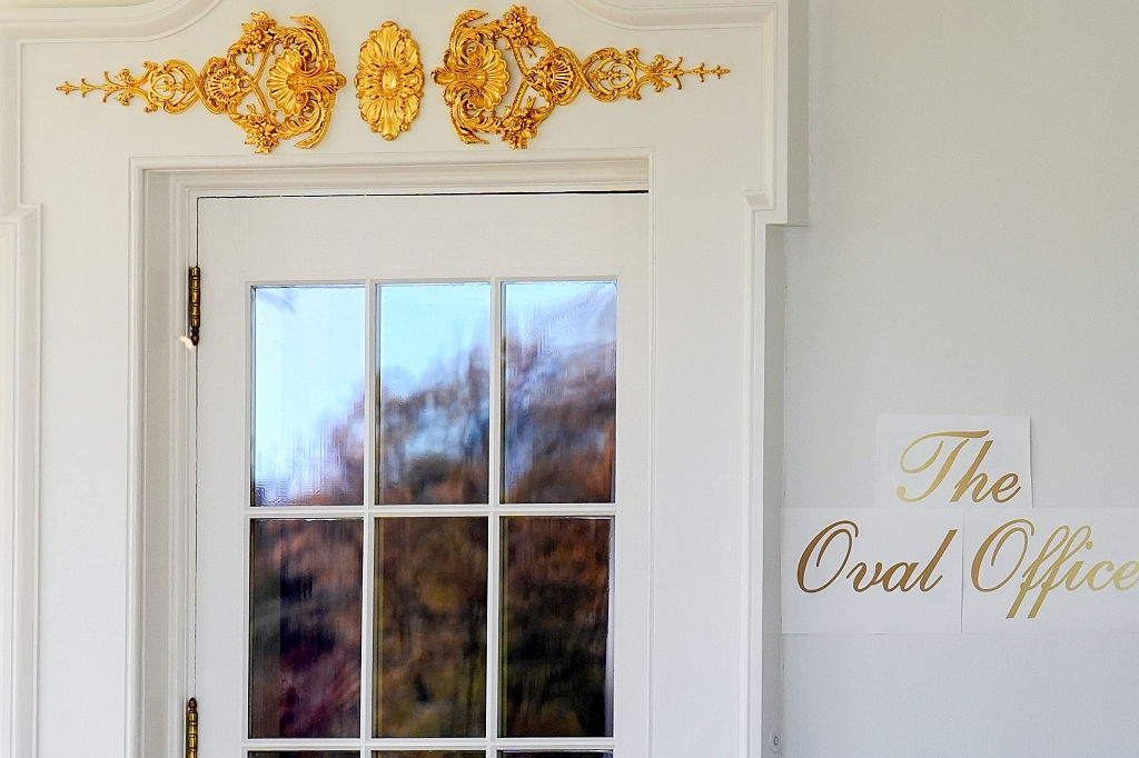 A glass-paned doorway with ornate decorations labeled "The Oval Office," suggesting a humorous oregon unexpected context