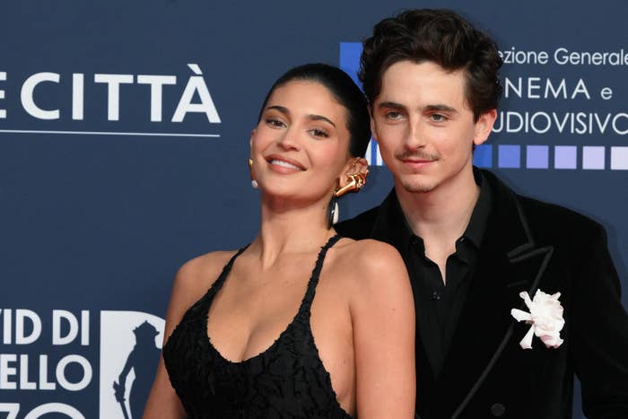Timothee Chalamet and Kylie Jenner airs  unneurotic  connected  a reddish  carpet; 1  wears a achromatic  dress, and the different   is successful  a achromatic  suit   with a floral pin