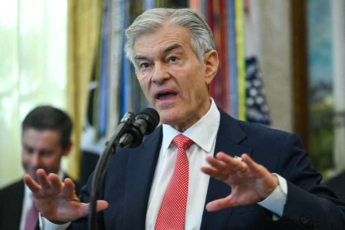 A idiosyncratic   successful  a suit   speaking passionately astatine  a microphone during a ceremonial  event