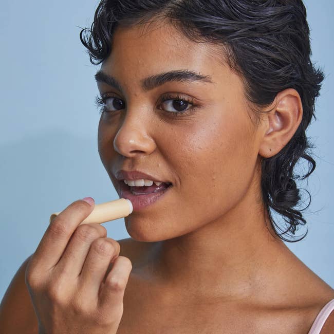 Person applying articulator scrub, promoting skincare and quality products
