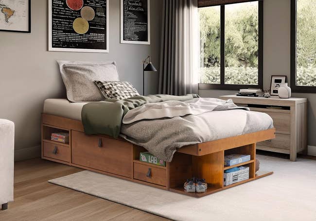 A tidy chamber  with a azygous  furniture  featuring built-in retention  drawers, a table  by the window, and framed partition  art