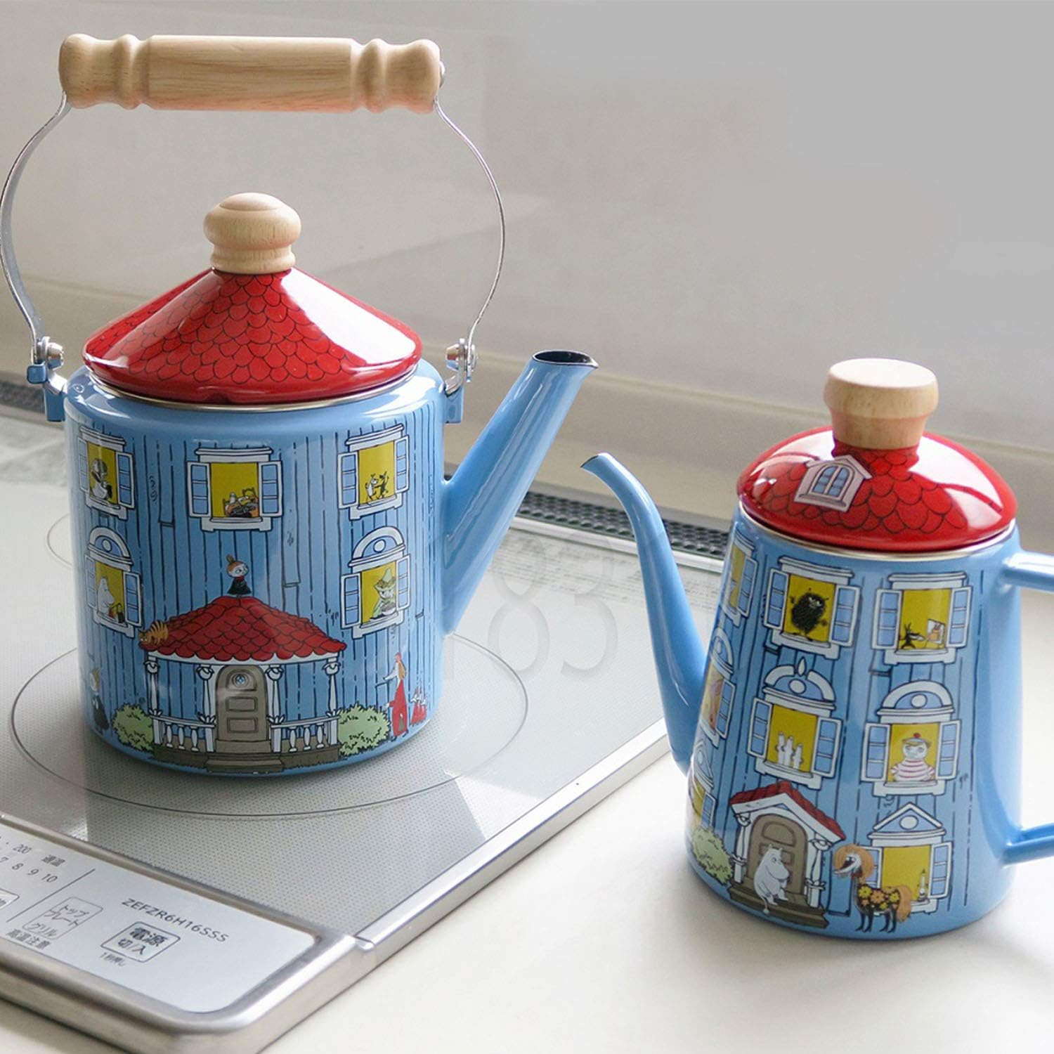 Tea kettles with illustrated house designs featuring windows and doors. Recommending for whimsical kitchen decor