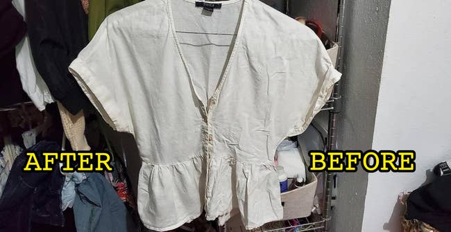 A cream-colored blouse with short sleeves and a peplum hem hangs in a closet, showcasing casual, feminine style fashion for shopping contexts