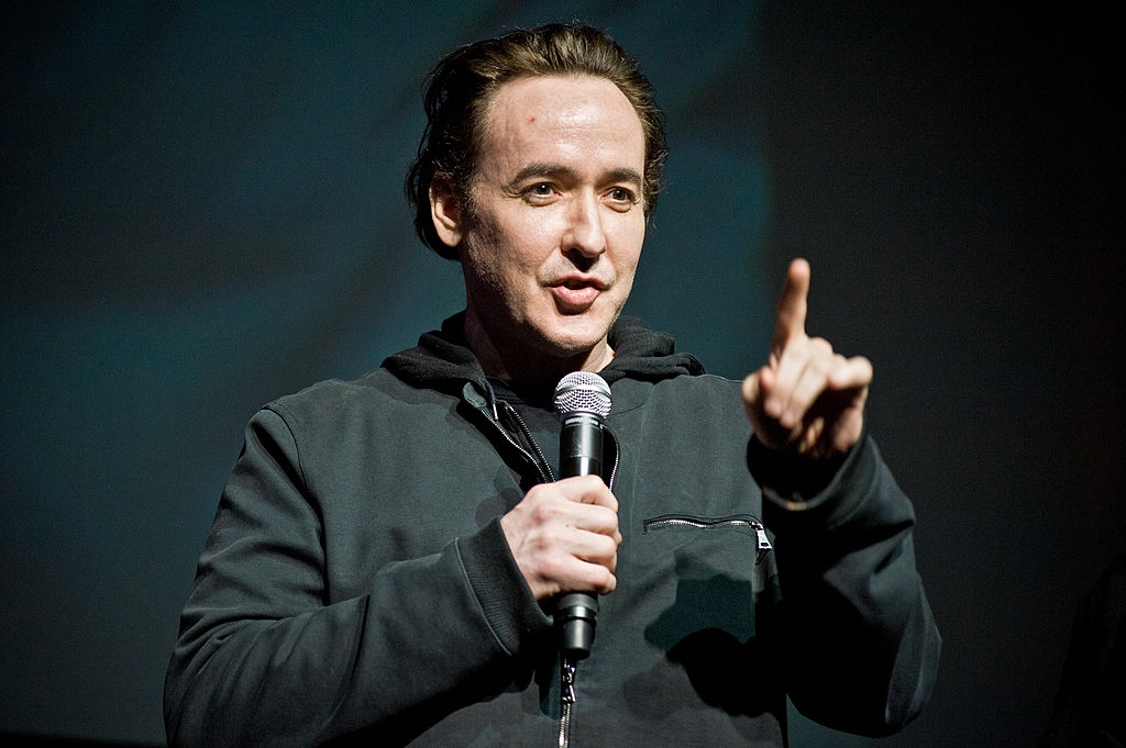 Cusack speaking into a microphone