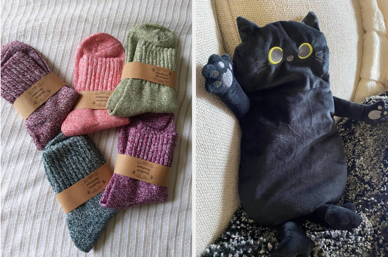 Four pairs of cozy knit socks in different shades and a plush cat-shaped hand warmer on a couch