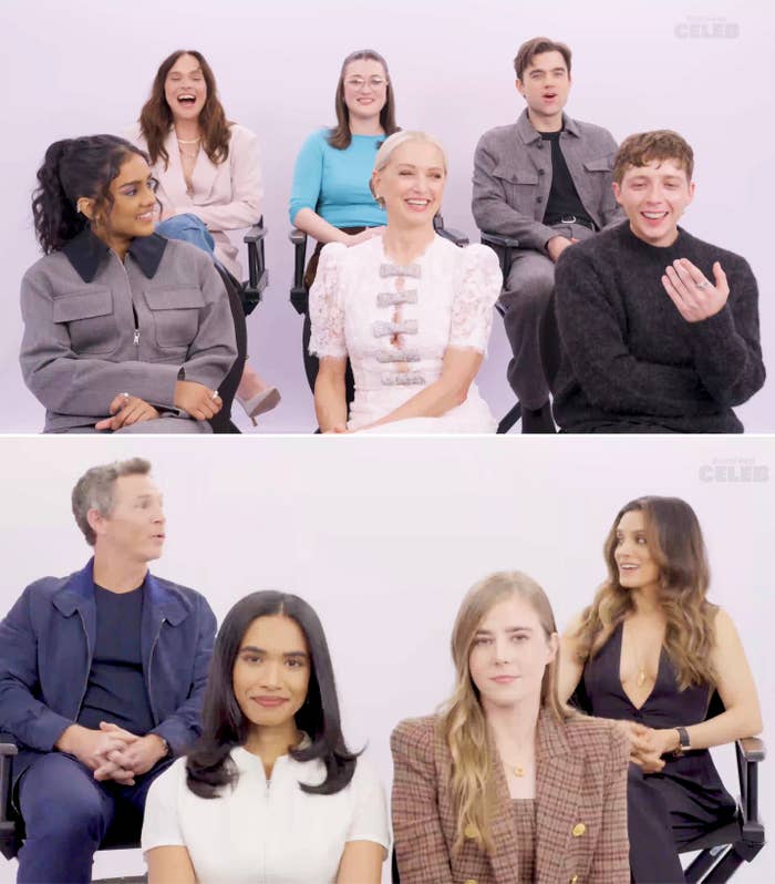 Group of actors seated in two rows, smiling and chatting; dressed in casual and formal attire