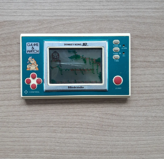 Handheld Nintendo Game & Watch featuring Donkey Kong Jr., with control buttons and a small screen displaying the game
