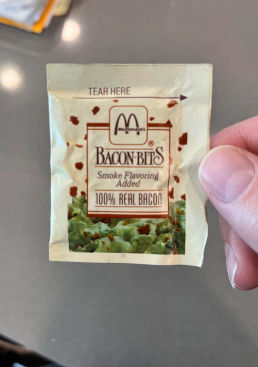 A vending machine bacon bits packet labeled 
