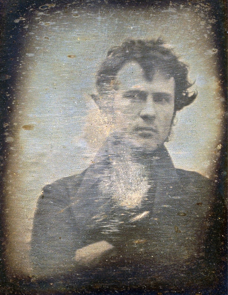 Portrait of a 19th-century antheral   with tousled hair, wearing a high-collared coat. The representation  has a vintage, weathered appearance