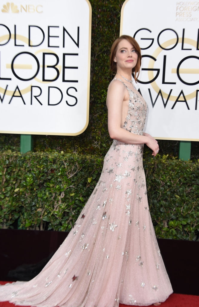 Actress on red carpet in a floor-length, sleeveless, embellished gown at the Golden Globe Awards