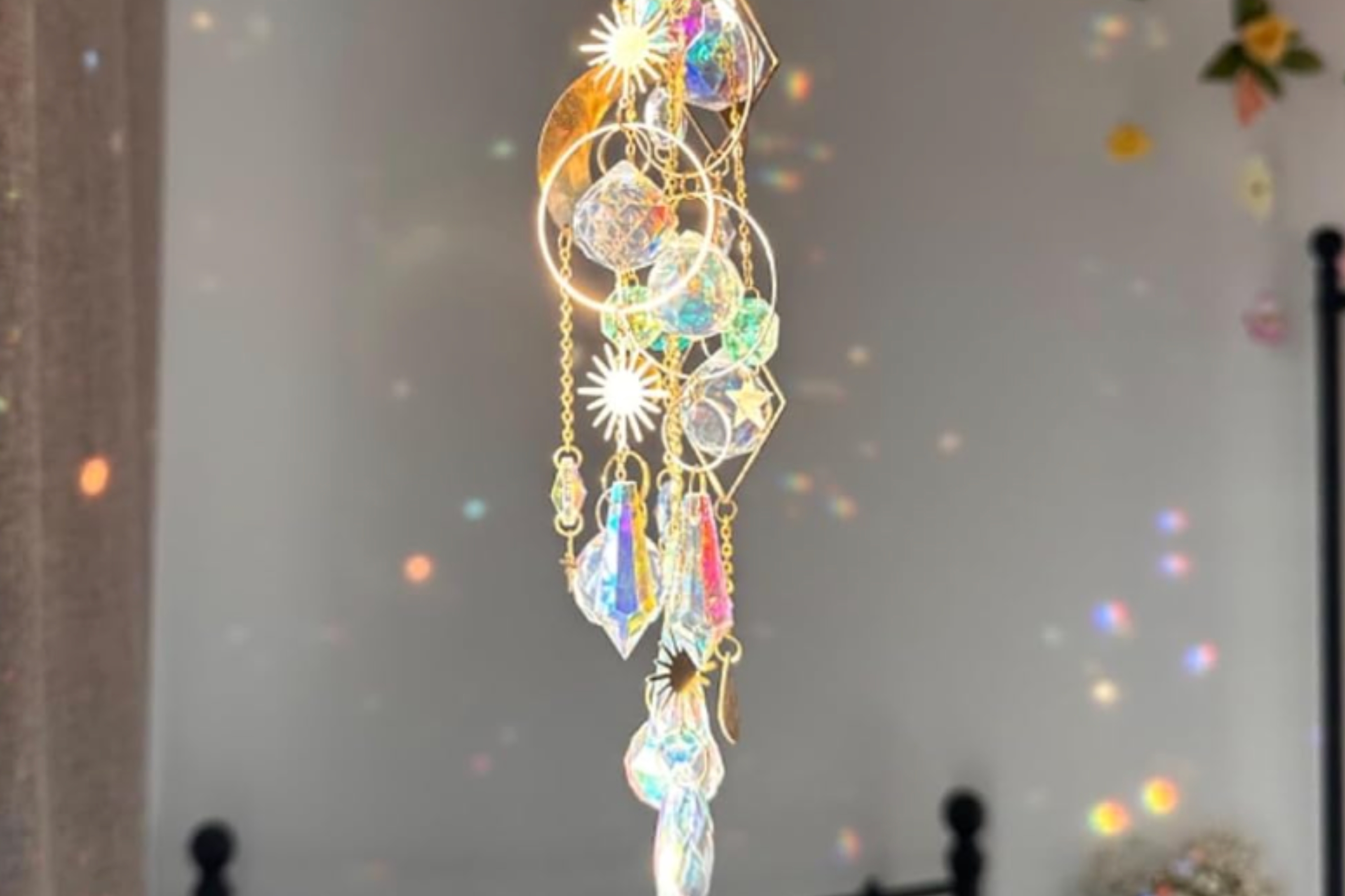 Crystal sun catcher hanging with reflective patterns on walls,