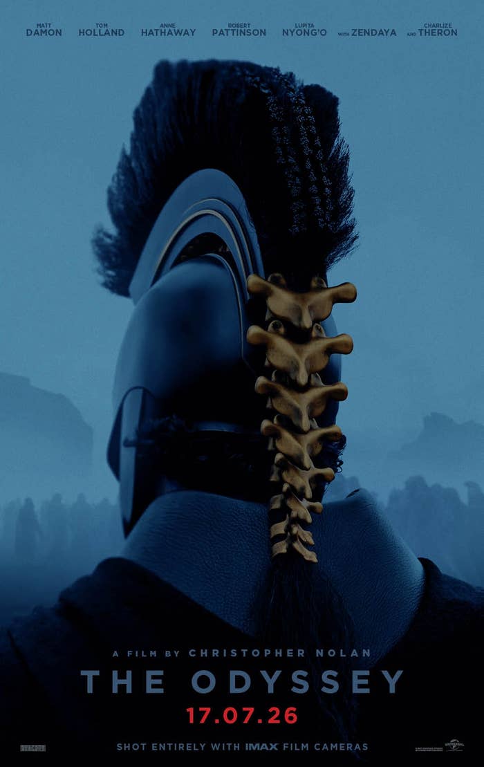 A warrior wearing a helmet with a decorative spine design is shown from behind, promoting Christopher Nolan's film "The Odyssey" releasing July 17, 2026