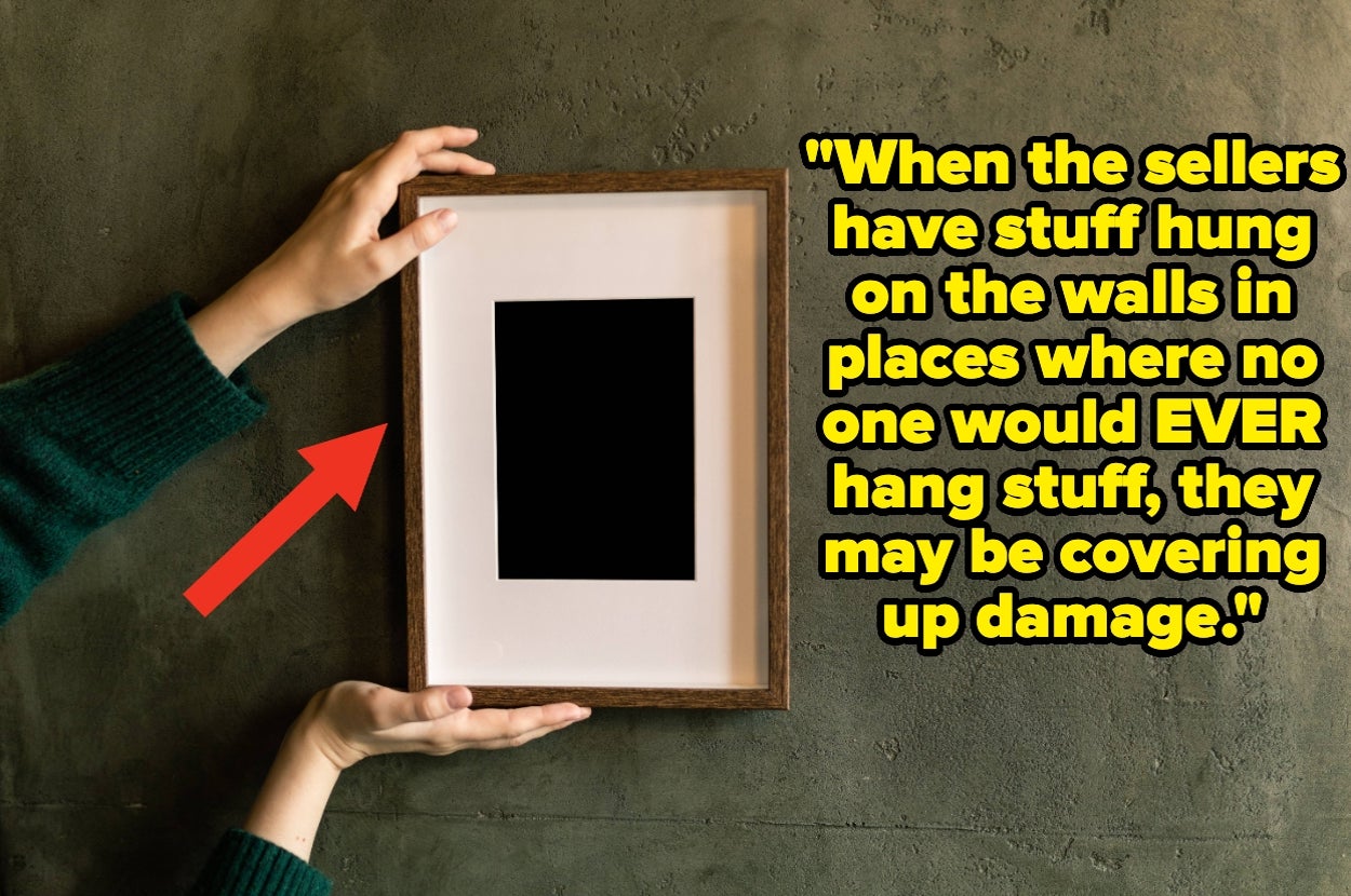 Hanging a picture, text overlay: "When the sellers have stuff hung on the walls in places where no one would EVER hang stuff, they may be covering up damage"