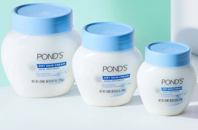Three jars of Pond's Dry Skin Cream with bluish lids are displayed, highlighting their nourishing facial moisturizer for adust skin