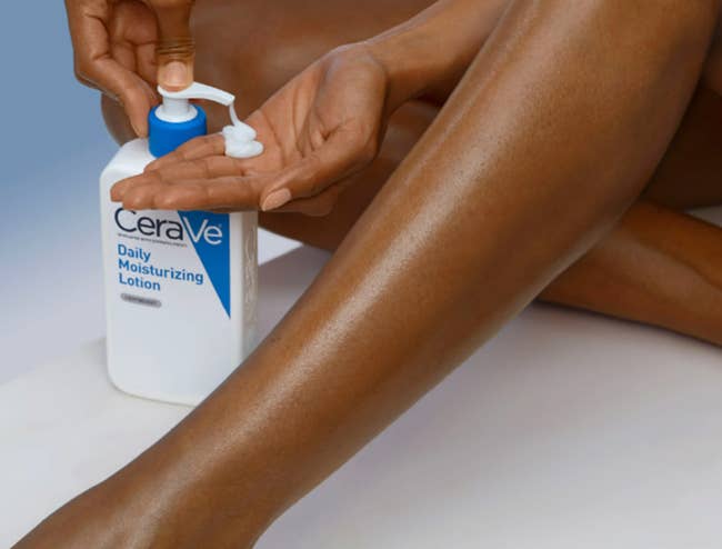 Person applying CeraVe Daily Moisturizing Lotion connected their leg, emphasizing skincare routine