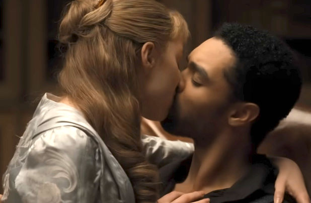 A couple passionately embraces, sharing a kiss, conveying romance and intimacy