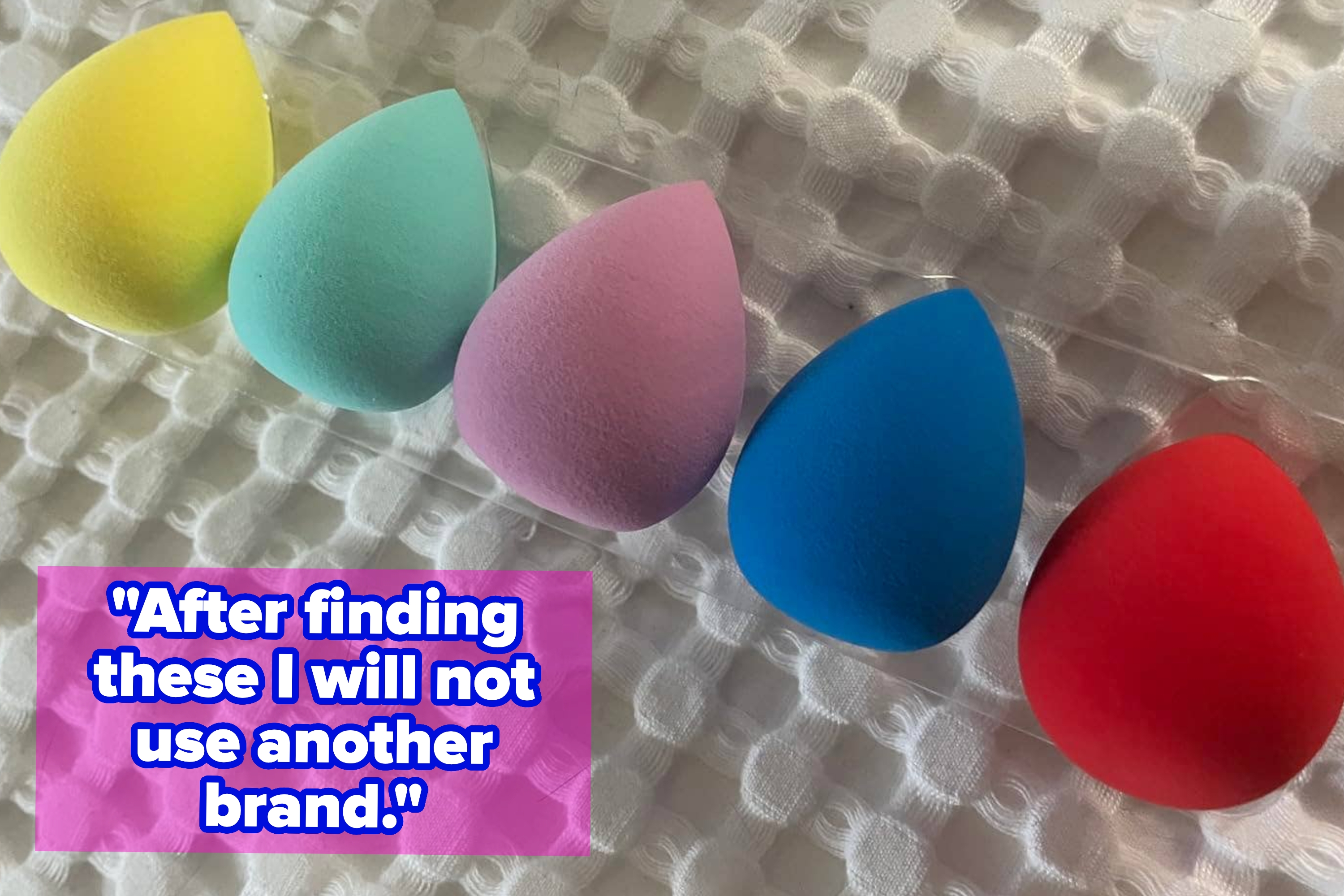 row of five makeup sponges, each a different color, with reviewer text "After finding these I will not use another brand."