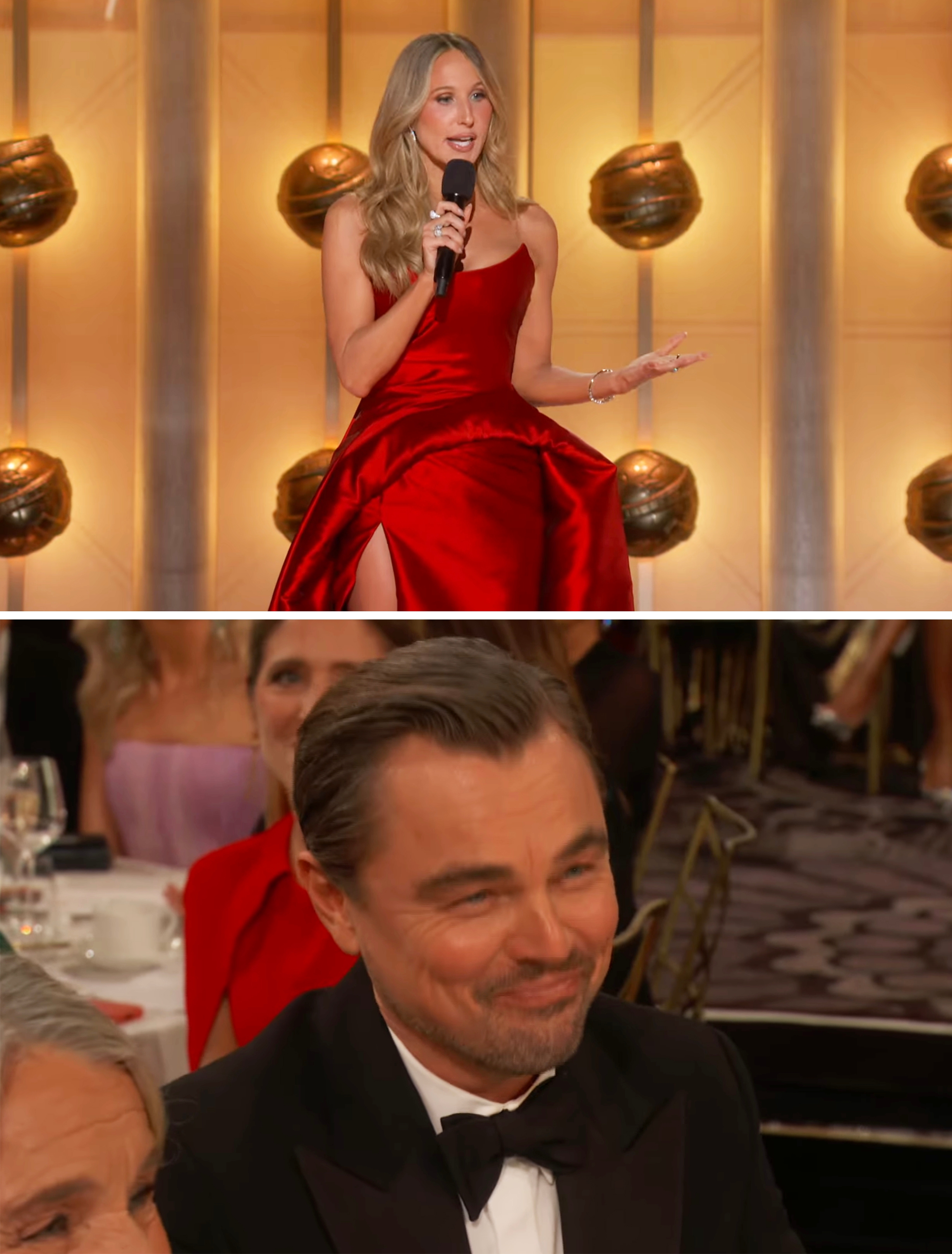 A pistillate   successful  an elegant reddish  gown speaks connected  signifier    with a microphone. A man, seated successful  the audience, wears a classical  achromatic  tuxedo and smiles